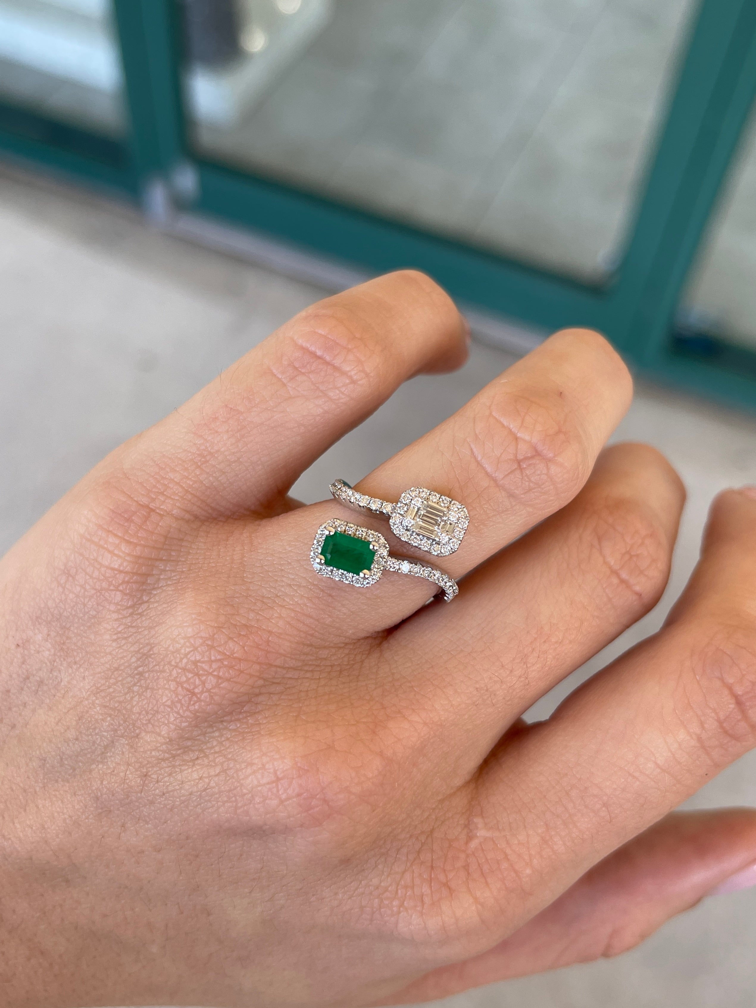 Ladies emerald ring with 1.51tcw dark green baguette and round cut Colombian emeralds on a bypass shank design.