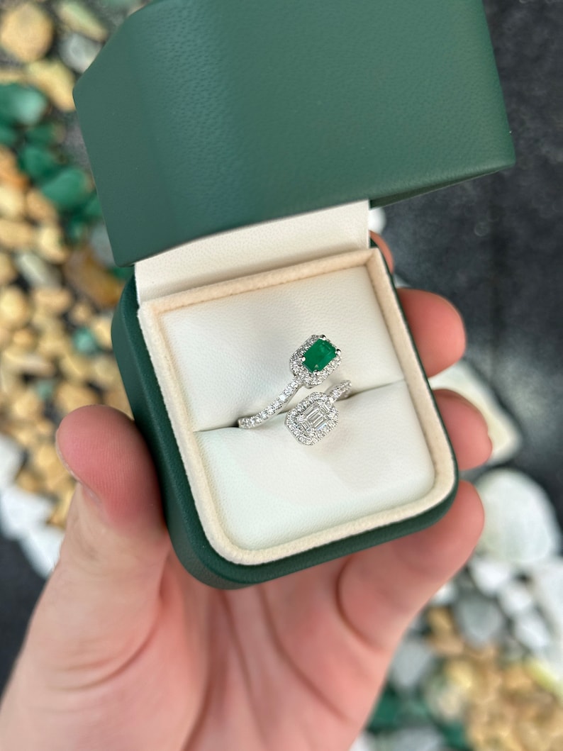 Ladies emerald ring featuring 1.51tcw Colombian emeralds, baguette and round cut green stones, 14K gold bypass shank, brilliant setting.
