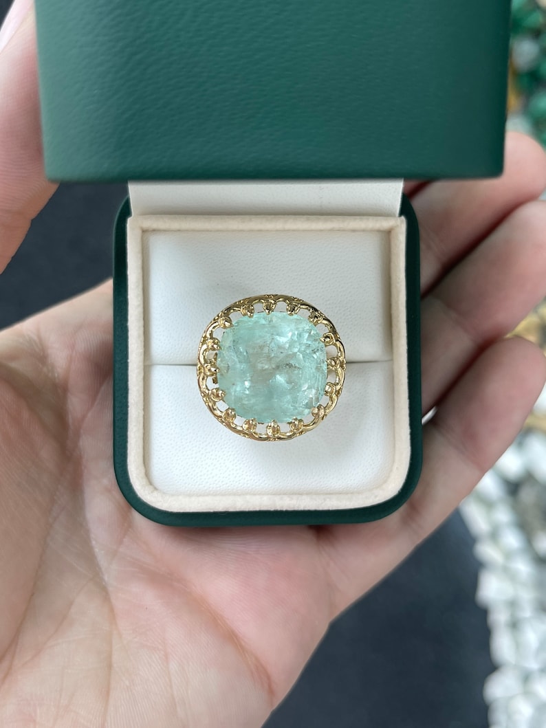 Large 16.75ct pale green cushion cut Colombian emerald ladies ring with vintage-inspired 14K gold setting and antique style.