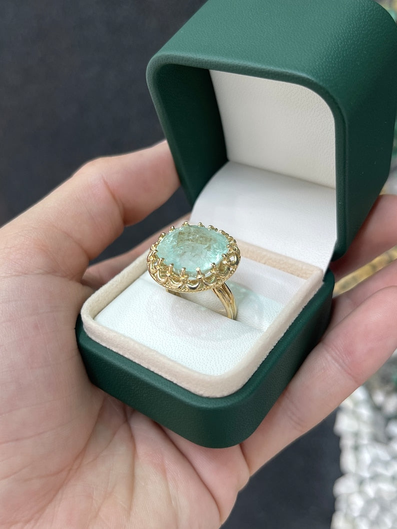 Large 16.75ct pale green cushion cut Colombian emerald ladies ring with vintage-inspired 14K gold setting.