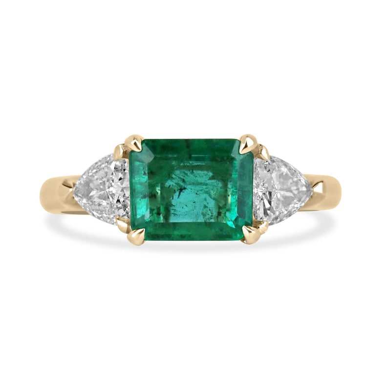 14K gold ladies emerald ring with east-west emerald and trillion-cut diamond accents, featuring a 2.58tcw Colombian emerald centerpiece