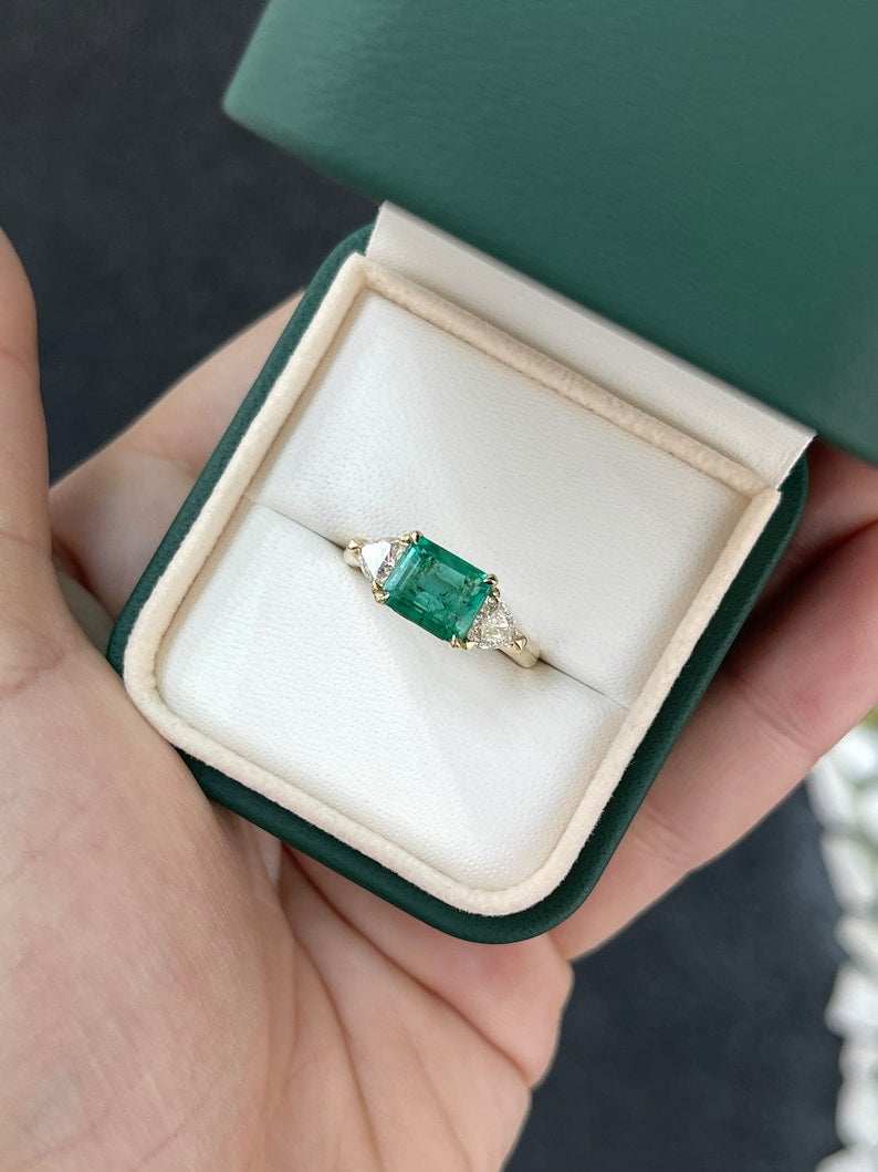 Ladies 14K gold emerald and trillion cut diamond 3-stone ring with 2.58 carats from Colombian Emerald brand.
