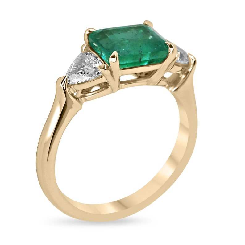 Ladies 14K gold emerald and trillion-cut diamond 3-stone ring with east-west design by Colombian Emerald.