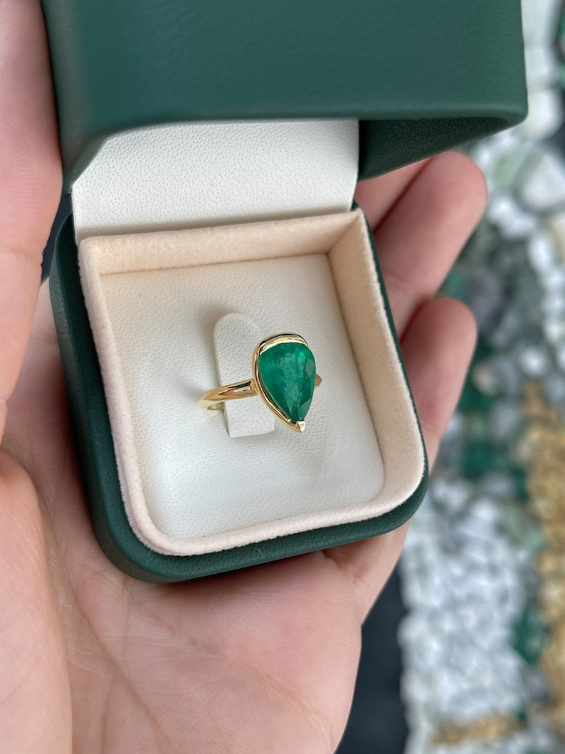 Ladies emerald ring with 3.10ct dark green pear-shaped Colombian emerald in 18K gold solitaire setting.