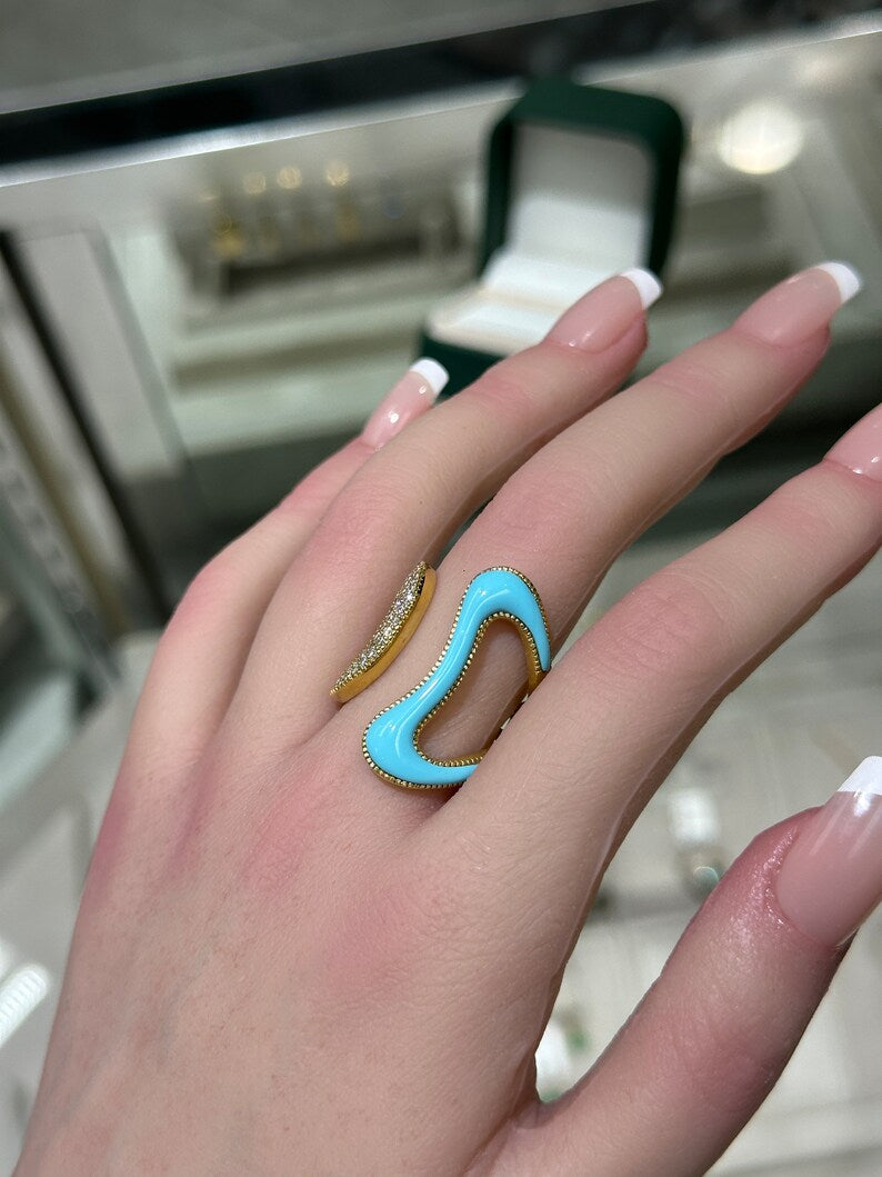 Ladies 14K gold statement ring with 0.40tcw pave diamonds and irregular turquoise, featuring a swirling open design by Colombian Emerald.