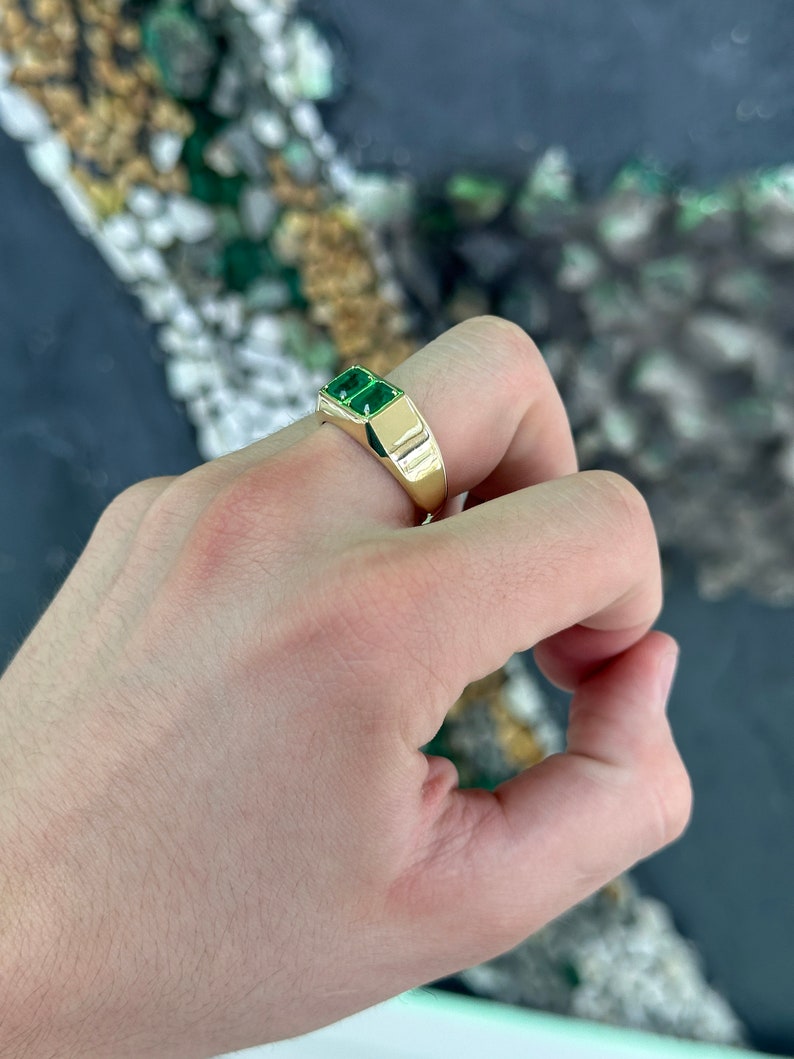 Double emerald duo men's unisex ring with 14K gold bezel setting, featuring 2.03 carats of Colombian emeralds.