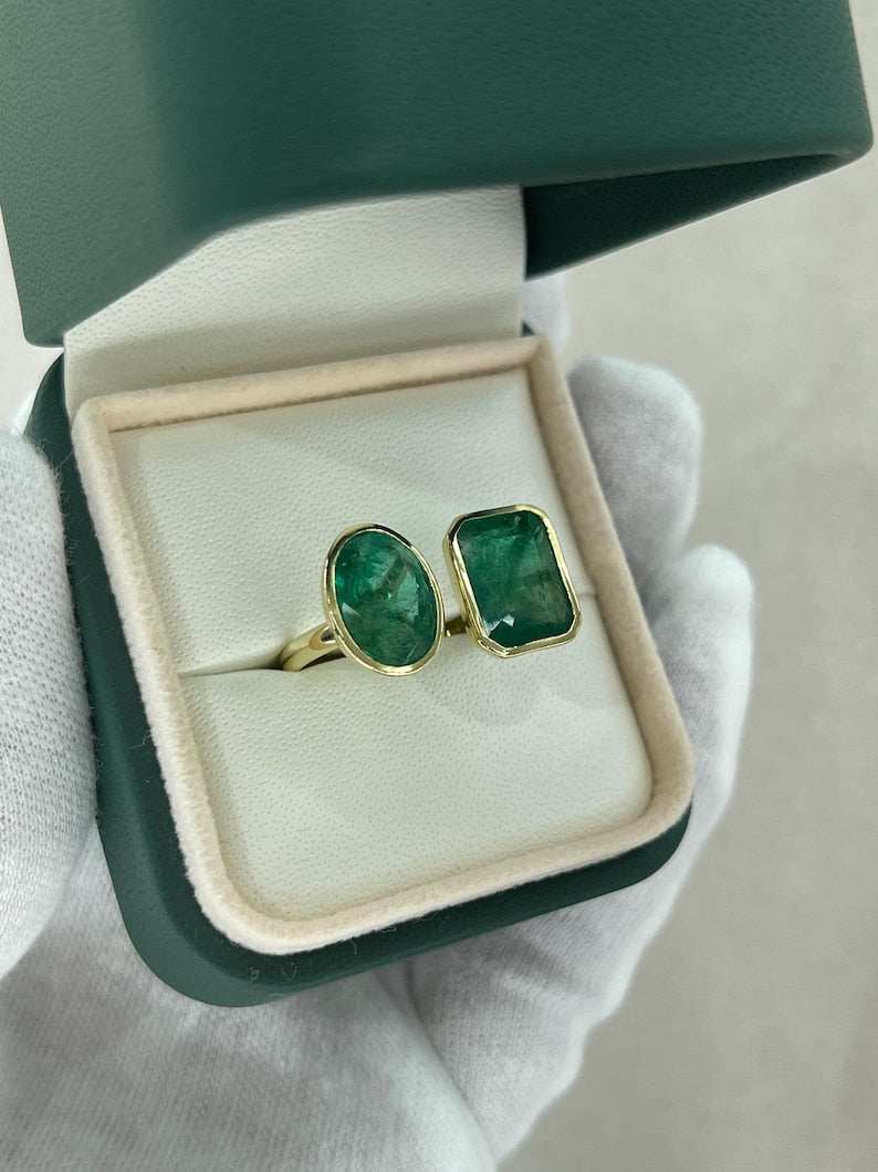 Men's 18K gold Toi Et Moi ring featuring deep green emerald and oval cut emerald stones by Colombian Emerald.