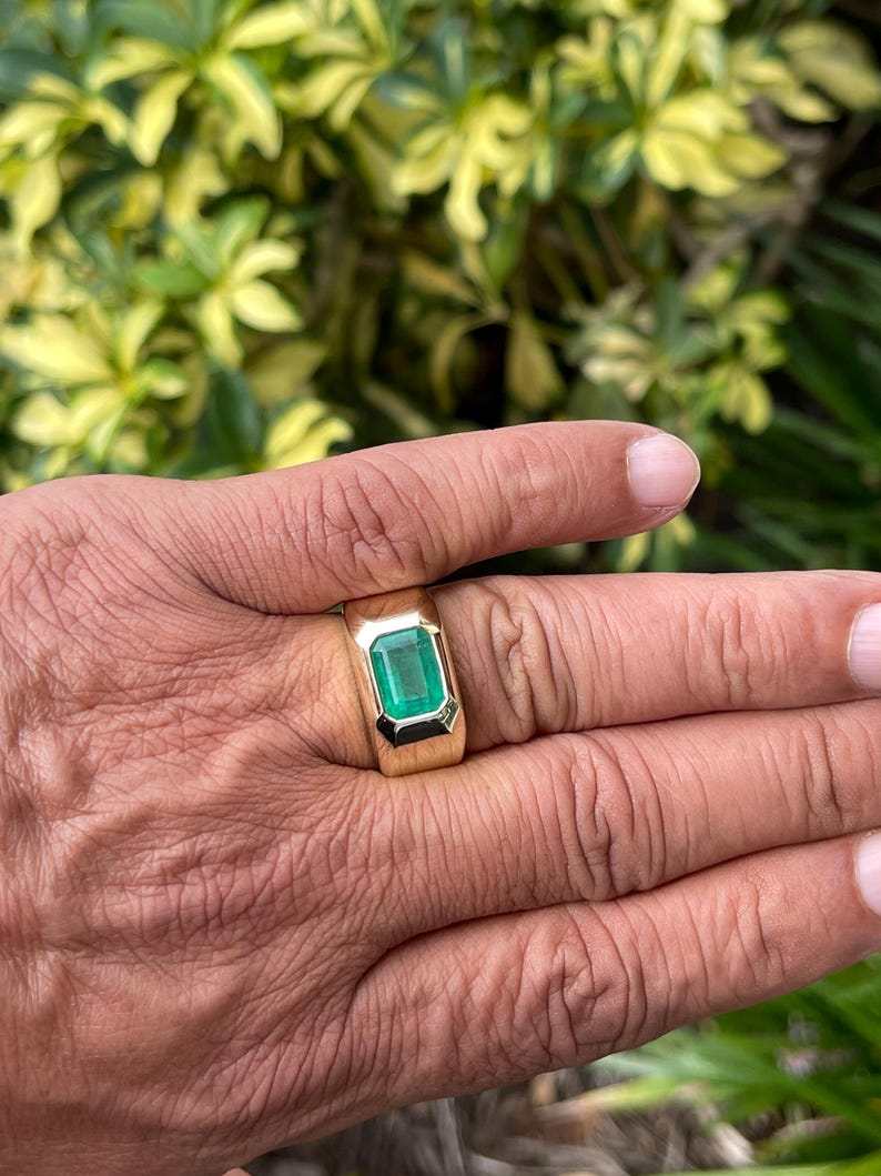 Men's 14K gold ring featuring a 4.40ct dark green emerald bezel-set solitaire, Colombian Emerald brand, heavy and elegant design.