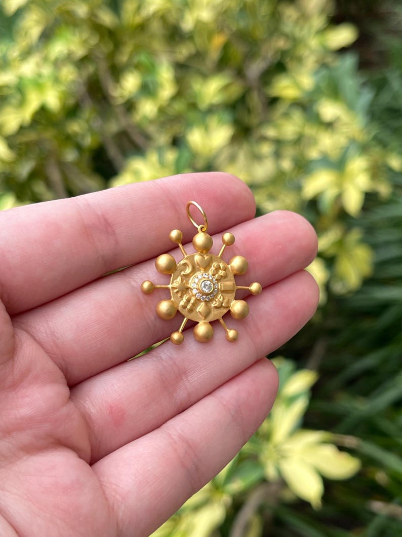 14K gold celestial pendant with 0.15cttw natural diamonds from Colombian Emerald, featuring a detailed star and moon design.