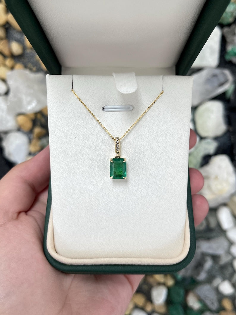 14K Colombian Emerald pendant necklace featuring a lush dark green emerald cut emerald with diamond accents.