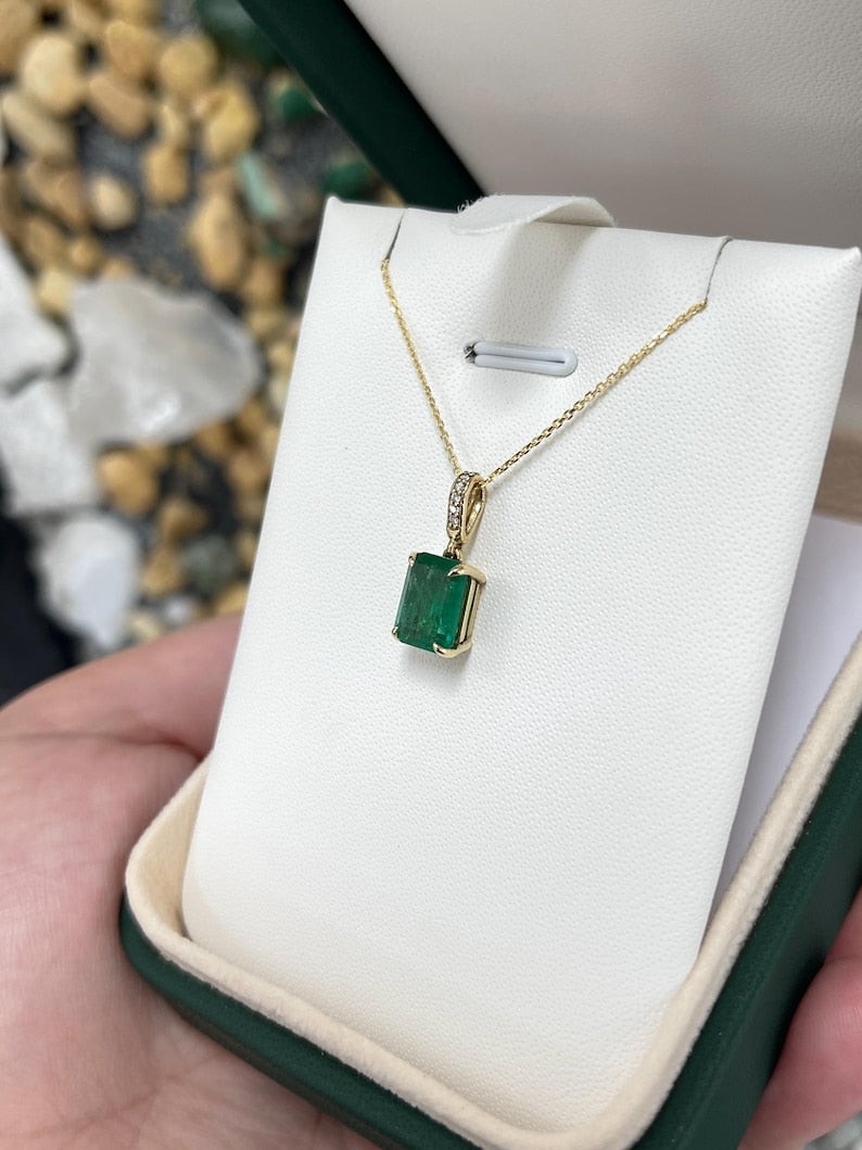 14K gold pendant necklace featuring a lush dark green emerald cut emerald with diamond accents by Colombian Emerald.