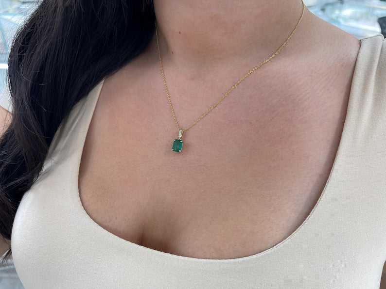 14K gold pendant necklace featuring a lush dark green emerald cut emerald and diamond accents by Colombian Emerald.