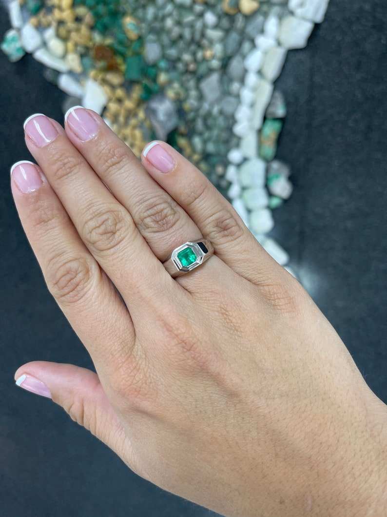 Men's silver ring with a 0.90 carat vivid medium green emerald, featuring pink accents, Colombian Emerald brand.