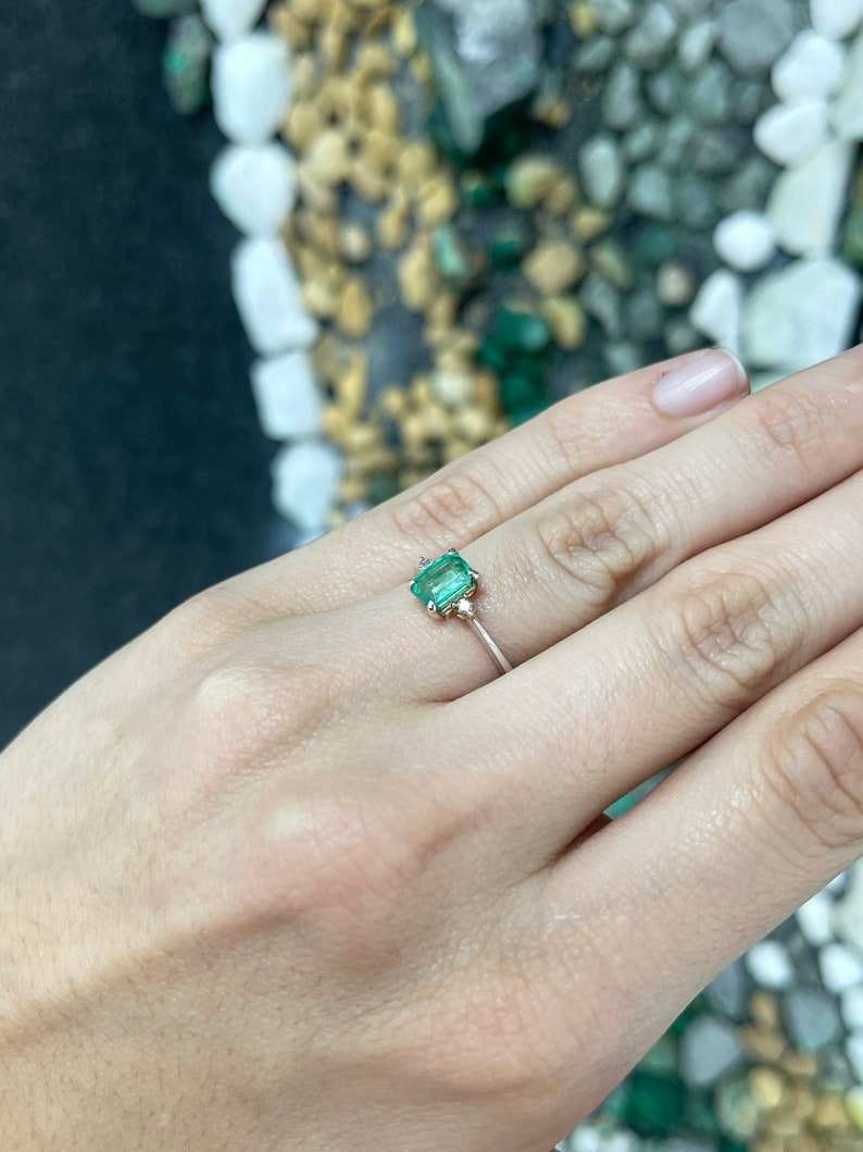 Sterling silver 3-stone ring with 0.98tcw natural medium green emerald cut and round brilliant diamonds by Colombian Emerald.
