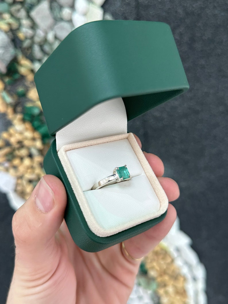Sterling silver 925 ring featuring a 1.30ct natural Asscher cut bluish green emerald with four prongs.