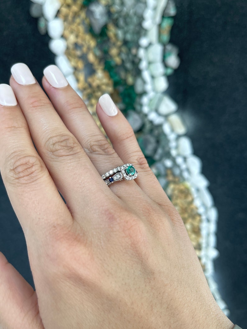 14K gold engagement ring with 1.44 carat natural emerald, sapphire accents, and diamond details from Colombian Emerald.