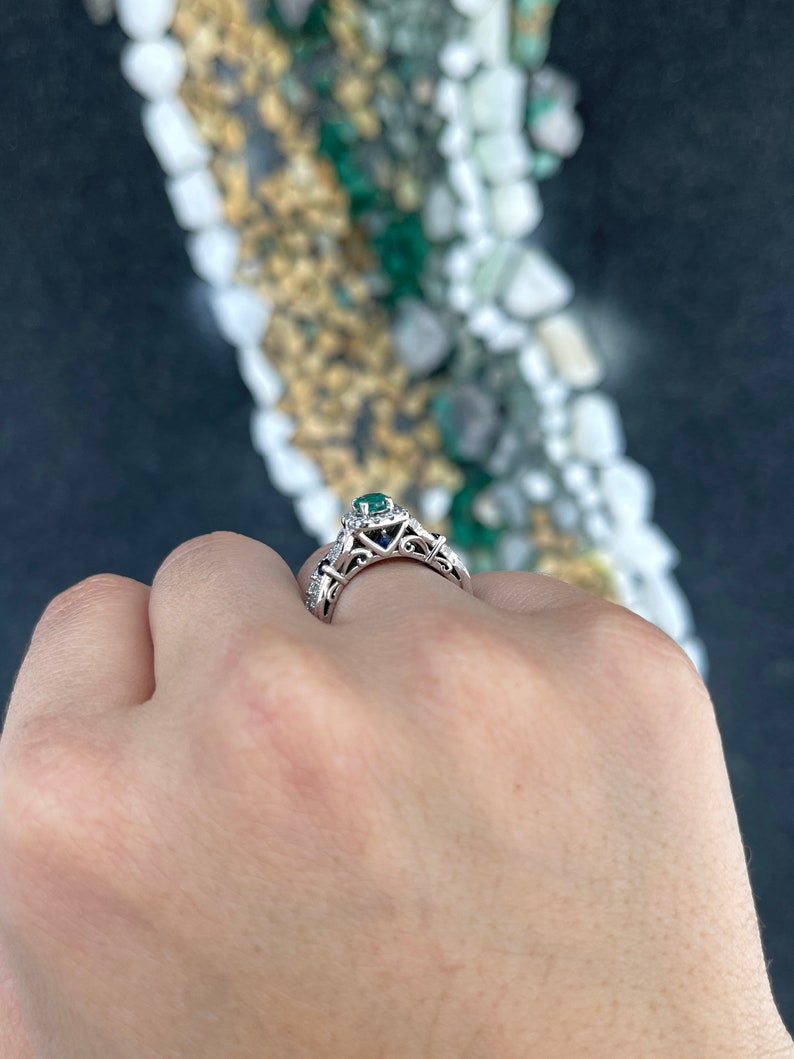 14K gold engagement ring with natural emerald, sapphire, and diamond accents, featuring intricate detailing by Colombian Emerald.