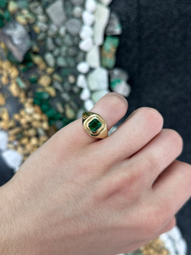 Unisex 1.48 Carat emerald solitaire ring with intense dark green Asscher cut gemstone and 18K gold bezel setting.