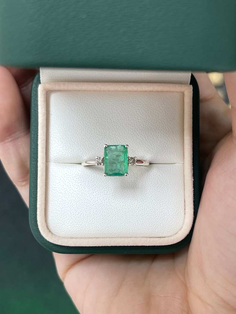 Sterling silver 3-stone ring with 1.70ctw green emerald cut and round diamond accents, designed by Colombian Emerald.