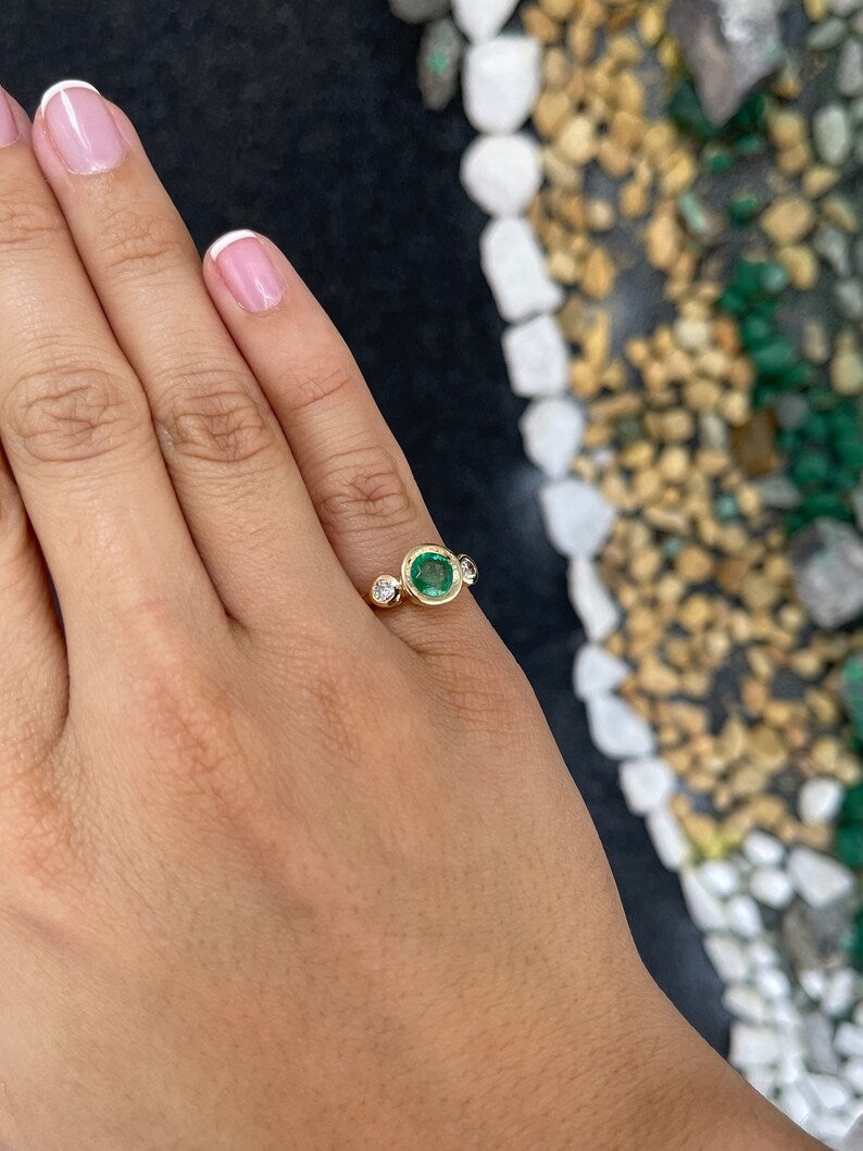 14K gold trilogy engagement ring featuring round cut medium spring green emerald and diamonds by Colombian Emerald.
