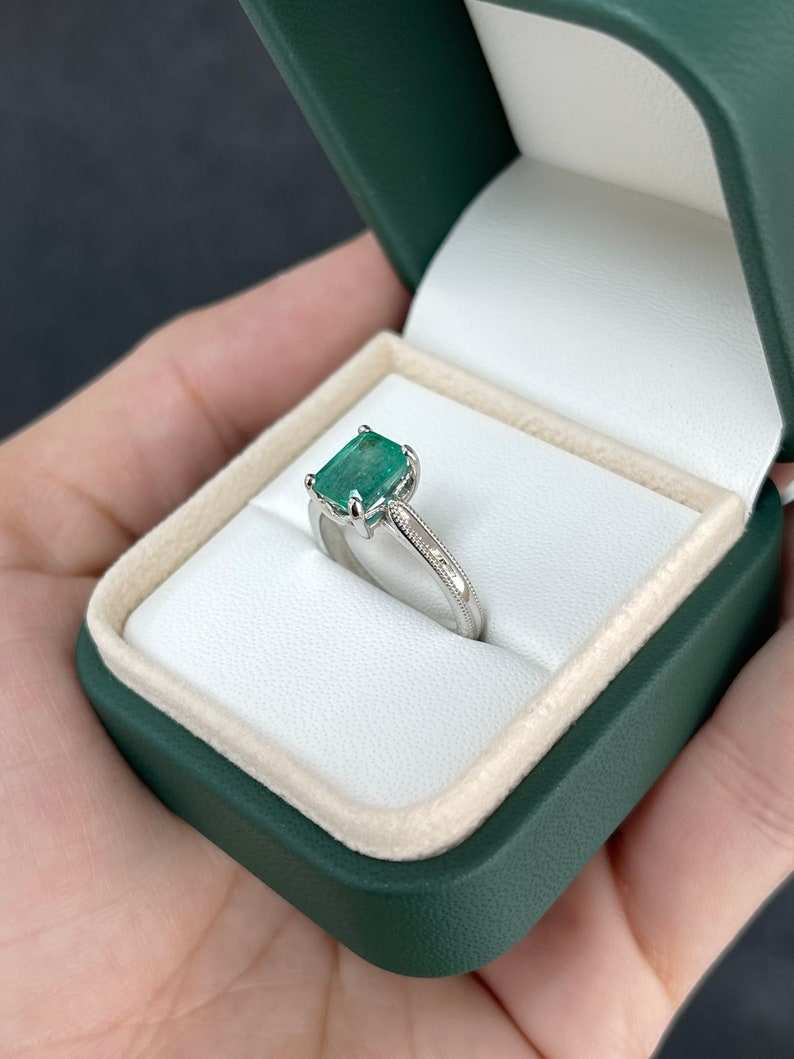 14K Colombian emerald engagement ring with a 1.95 carat four-prong solitaire setting on a white background.