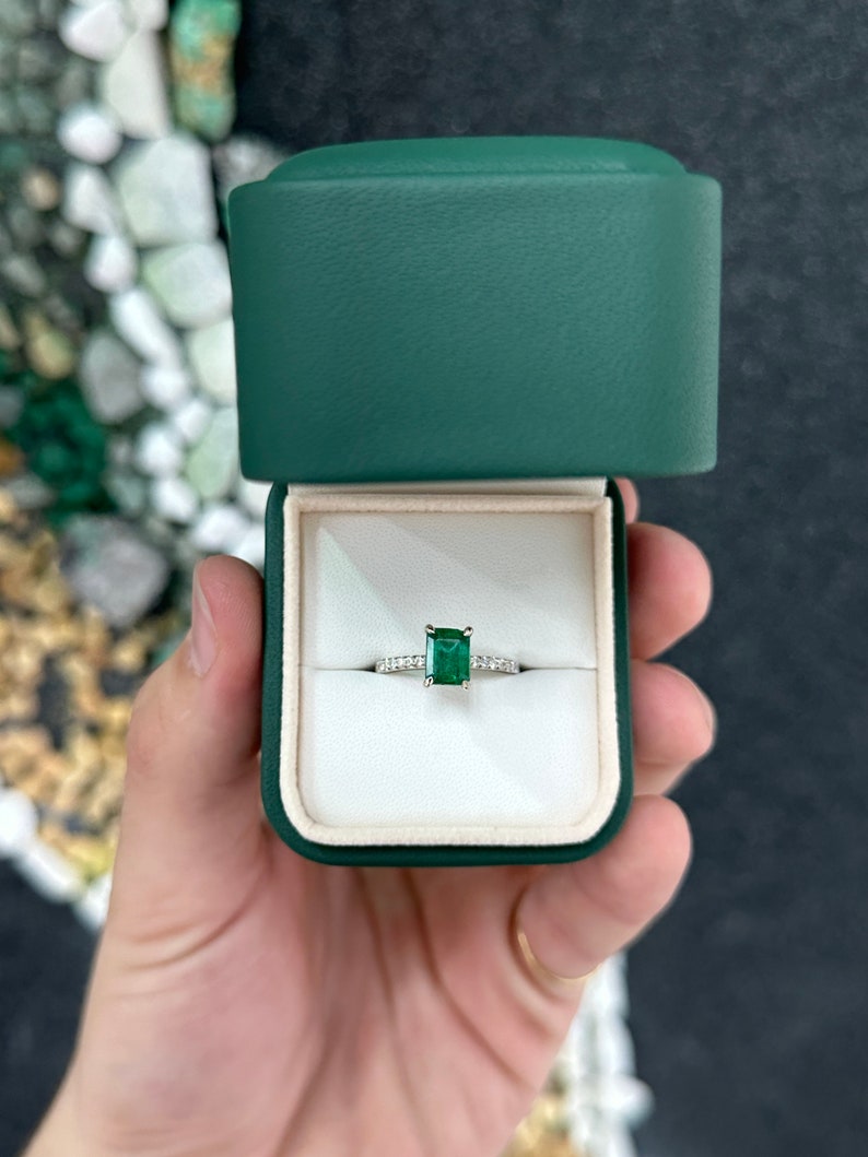 14K white gold engagement ring with a rich dark green emerald and diamond accents, designed for right hand wear.