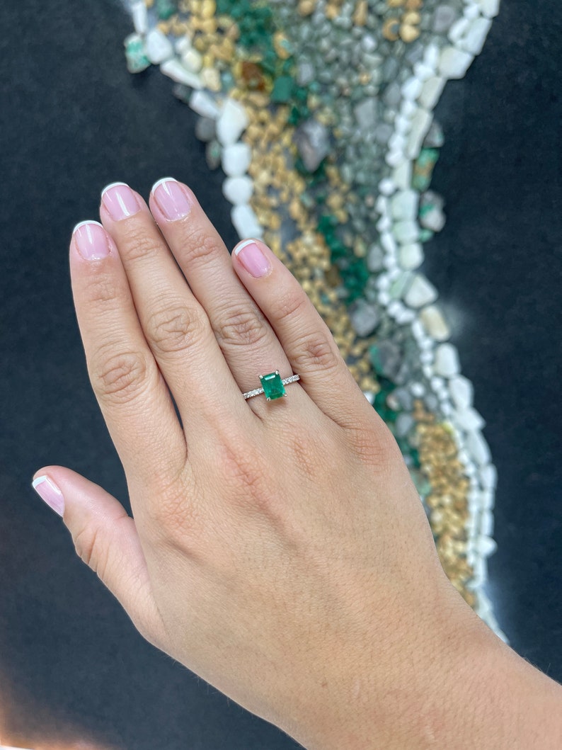 14K white gold engagement ring with a rich dark green emerald and diamond accents, designed for right hand wear.