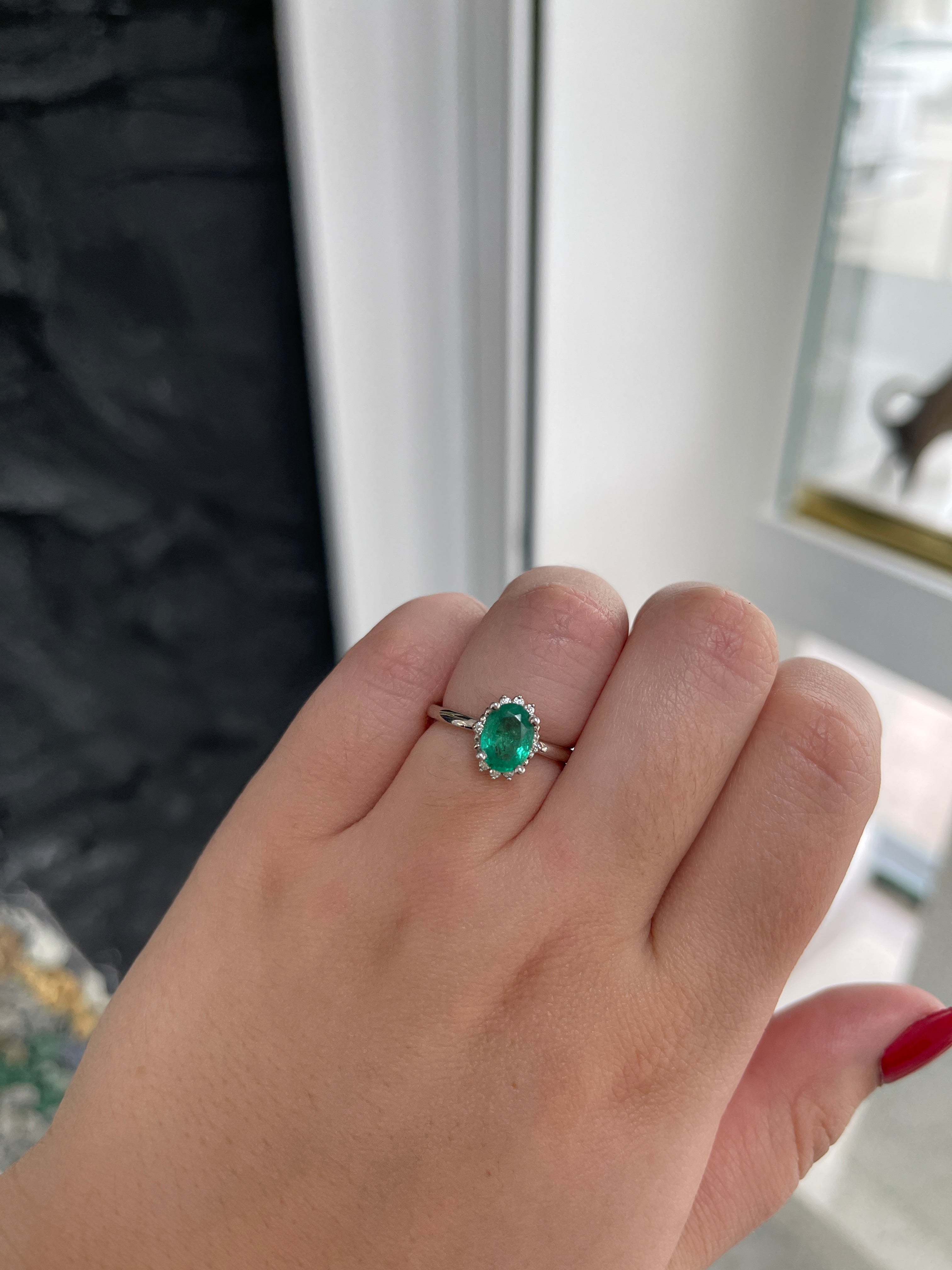 14K gold emerald ring with oval cut natural emerald and dark green diamond accents, featuring a petite medium design.