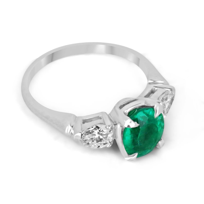 Colombian Emerald three-stone engagement ring featuring a vivid dark green emerald with diamond accents in a fine quality design.