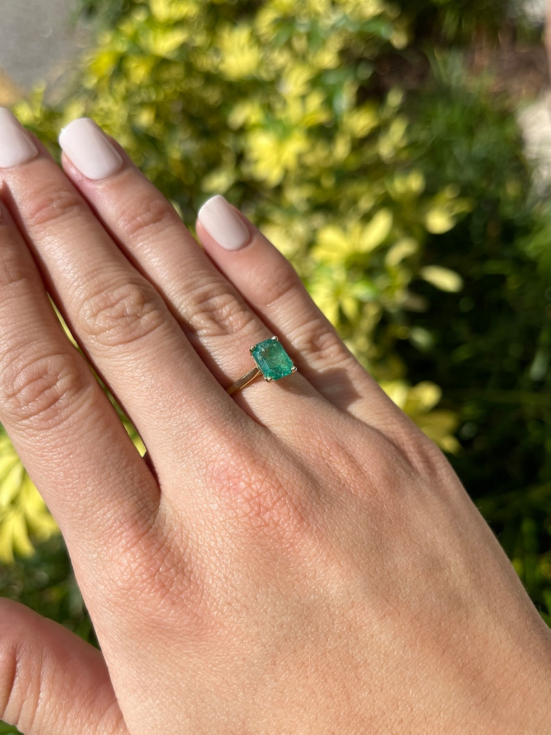 14K gold emerald cut green emerald ring with four prongs, designed as a right-hand solitaire ring by Colombian Emerald.