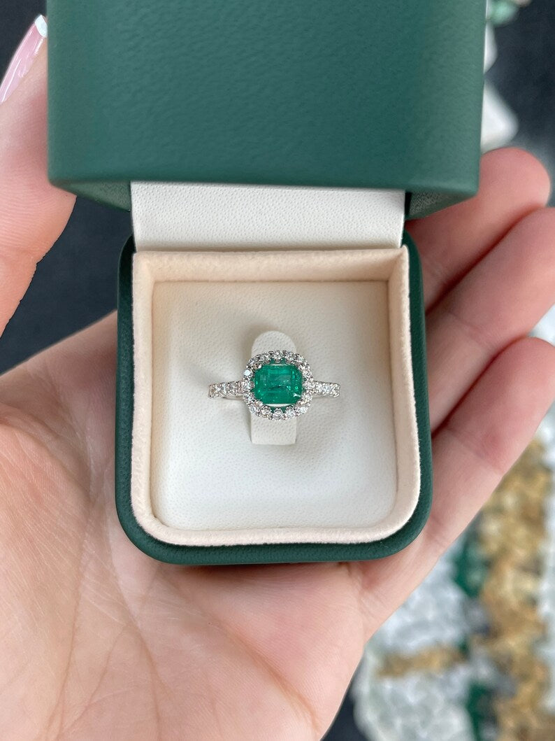 East to West emerald and diamond halo engagement ring in 14K gold with Colombian emeralds and intricate detailing.