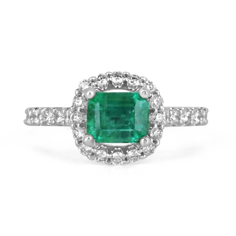 East to West emerald and diamond halo engagement ring in 14K gold with Colombian emeralds and detailed shank design.