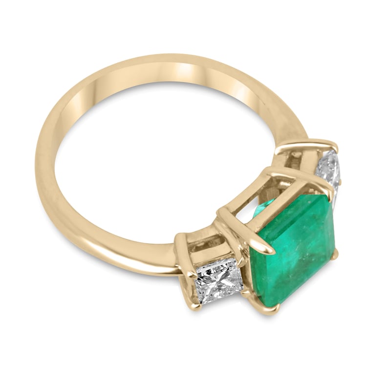 Colombian Emerald and princess cut diamond 3-stone ring in 14K gold, showcasing vibrant green emeralds and sparkling diamonds.