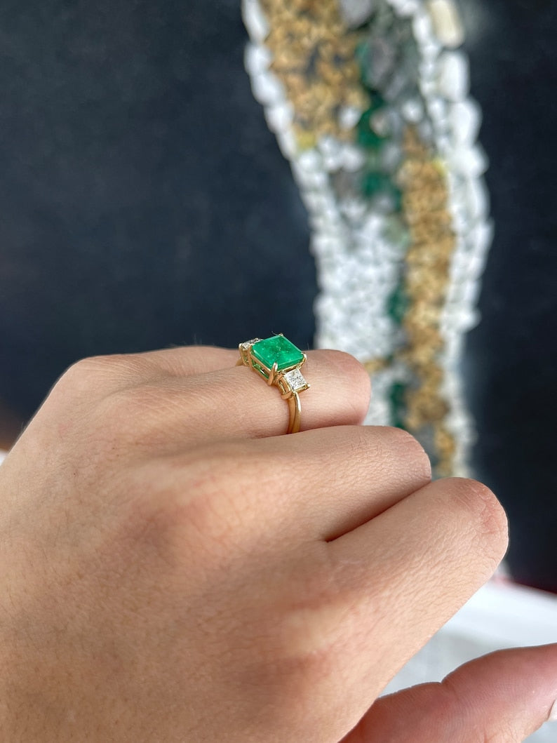 Colombian Emerald and princess cut diamond 3-stone ring in 14K gold, featuring vibrant green emeralds and sparkling diamonds.
