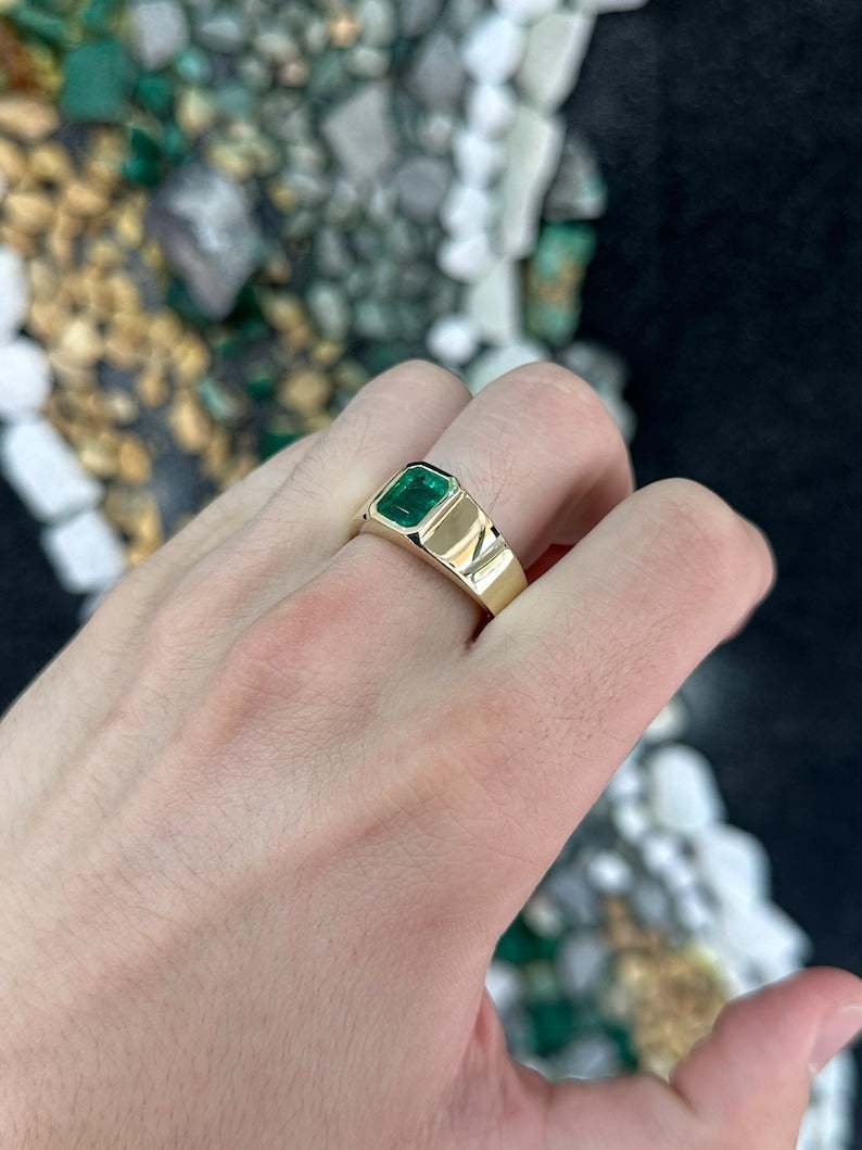Men's 14K gold ring with a 2.65ct lush dark green emerald cut Colombian Emerald, featuring a north-to-south setting.