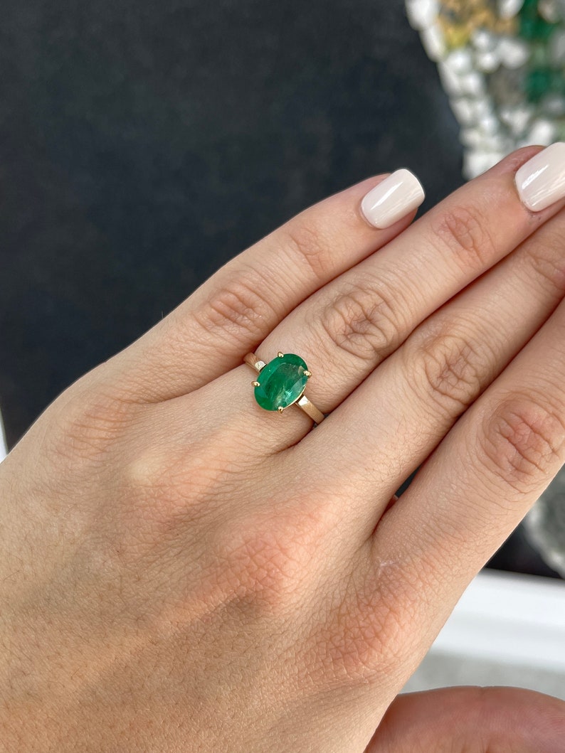 14K gold oval cut forest green emerald ring with 4-prong solitaire setting, Colombian Emerald brand, designed for right hand wear