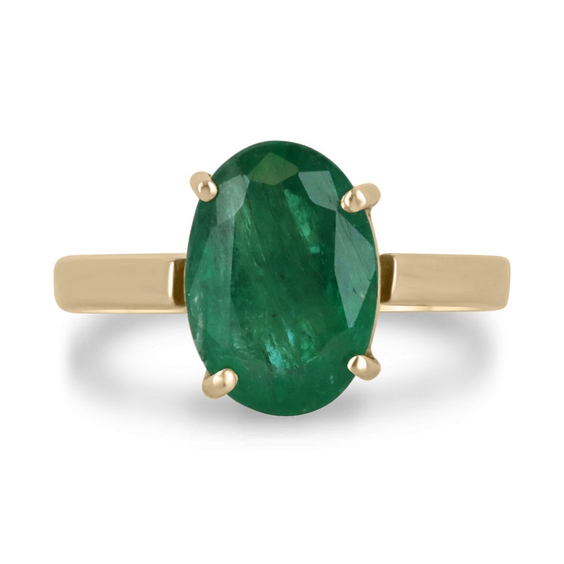 14K gold oval cut forest green emerald solitaire ring with 4 prongs, designed for right hand wear, by Colombian Emerald.