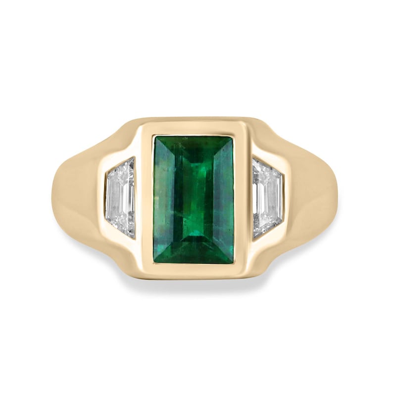 Unisex 18K gold ring featuring a 3.30tcw dark green emerald and three diamond accents, designed by Colombian Emerald.
