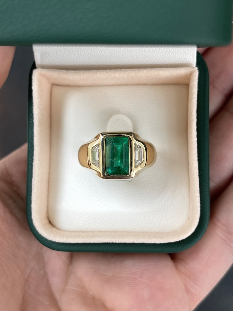 Unisex 18K gold ring with 3.30tcw dark green emerald and three diamond accents, Colombian Emerald brand, men's jewelry.