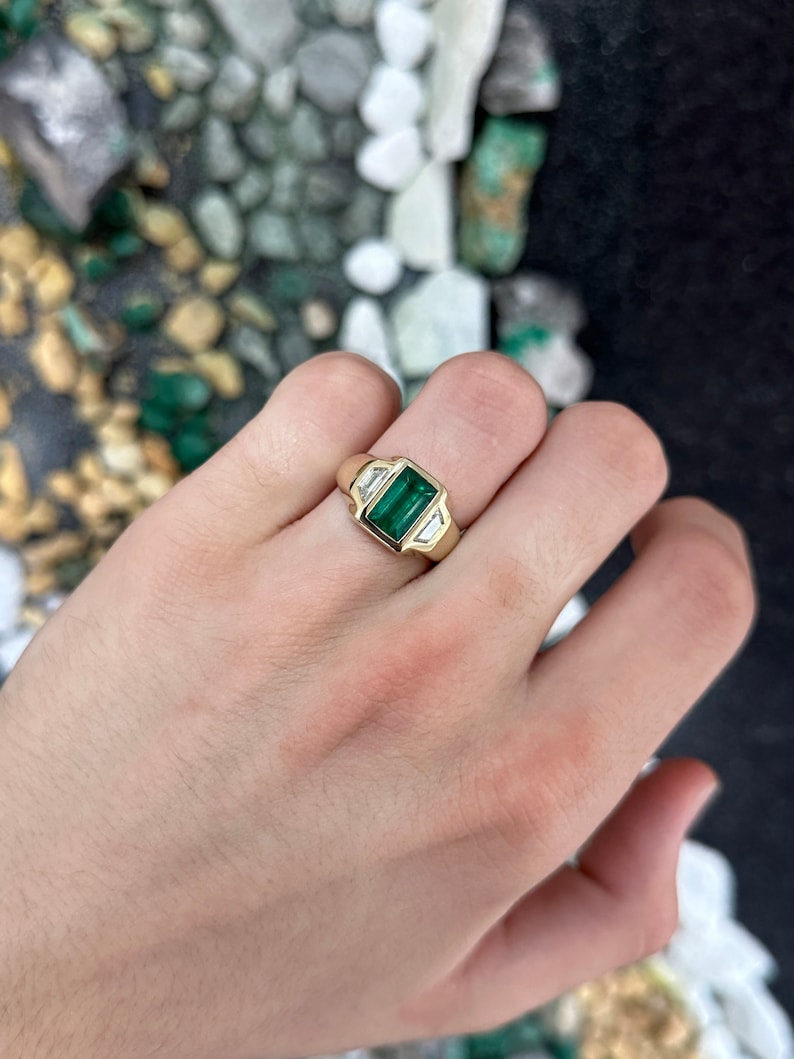 Unisex 18K gold ring featuring a 3.30tcw dark green emerald and three diamonds, crafted by Colombian Emerald.