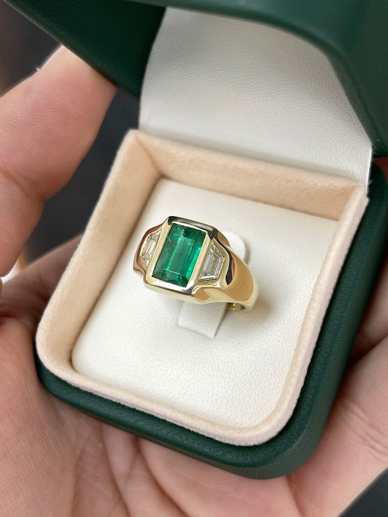 Unisex 18K gold ring with 3.30tcw dark green emerald and Cadillac diamonds, three-stone design, Colombian Emerald brand.