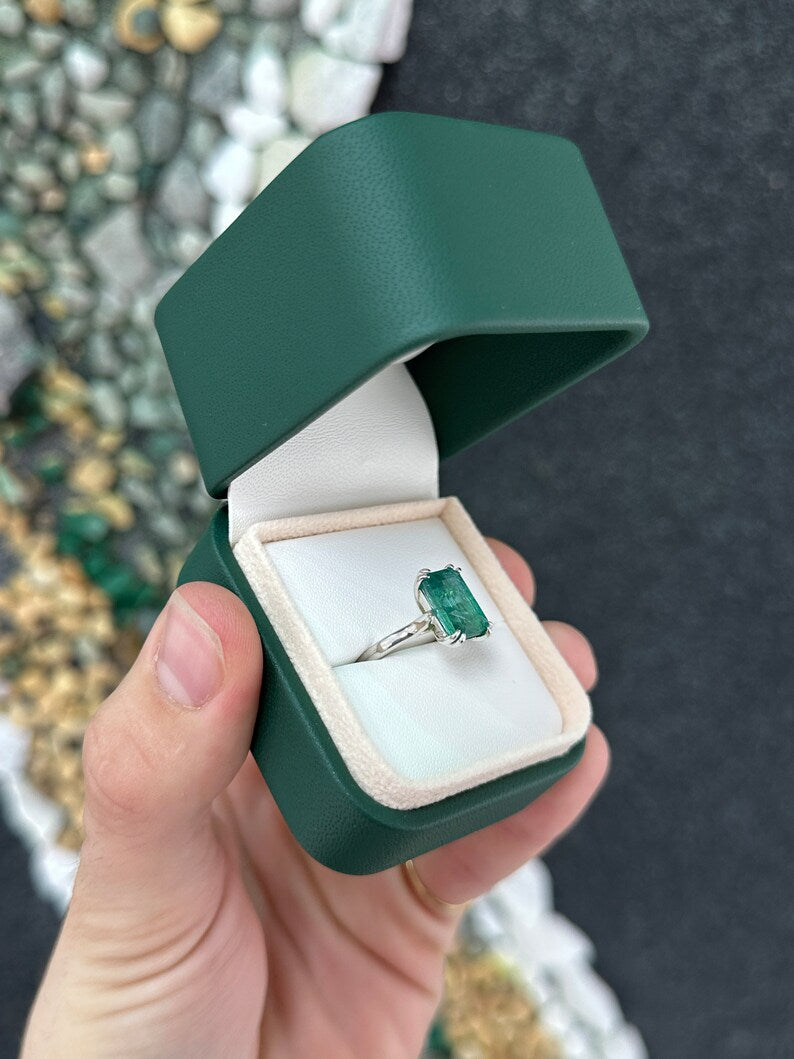 14K gold emerald cut dark green emerald solitaire ring with double claw prongs, featuring a 3.95ct Colombian Emerald.
