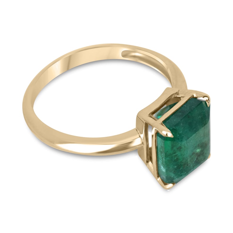 14K gold emerald cut solitaire engagement ring with a 4.08ct rich green emerald from Colombian Emerald, featuring four prongs.