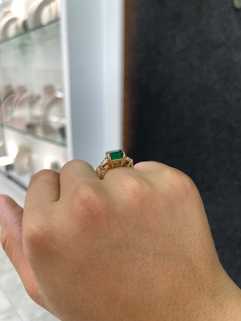 14K gold Colombian Emerald engagement ring with natural trillion and asscher cut emeralds and diamonds, three-stone design.