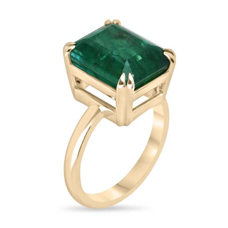 Colombian Emerald 7.90ct large emerald cut double claw prong solitaire ring on right hand, 18K gold jewelry.