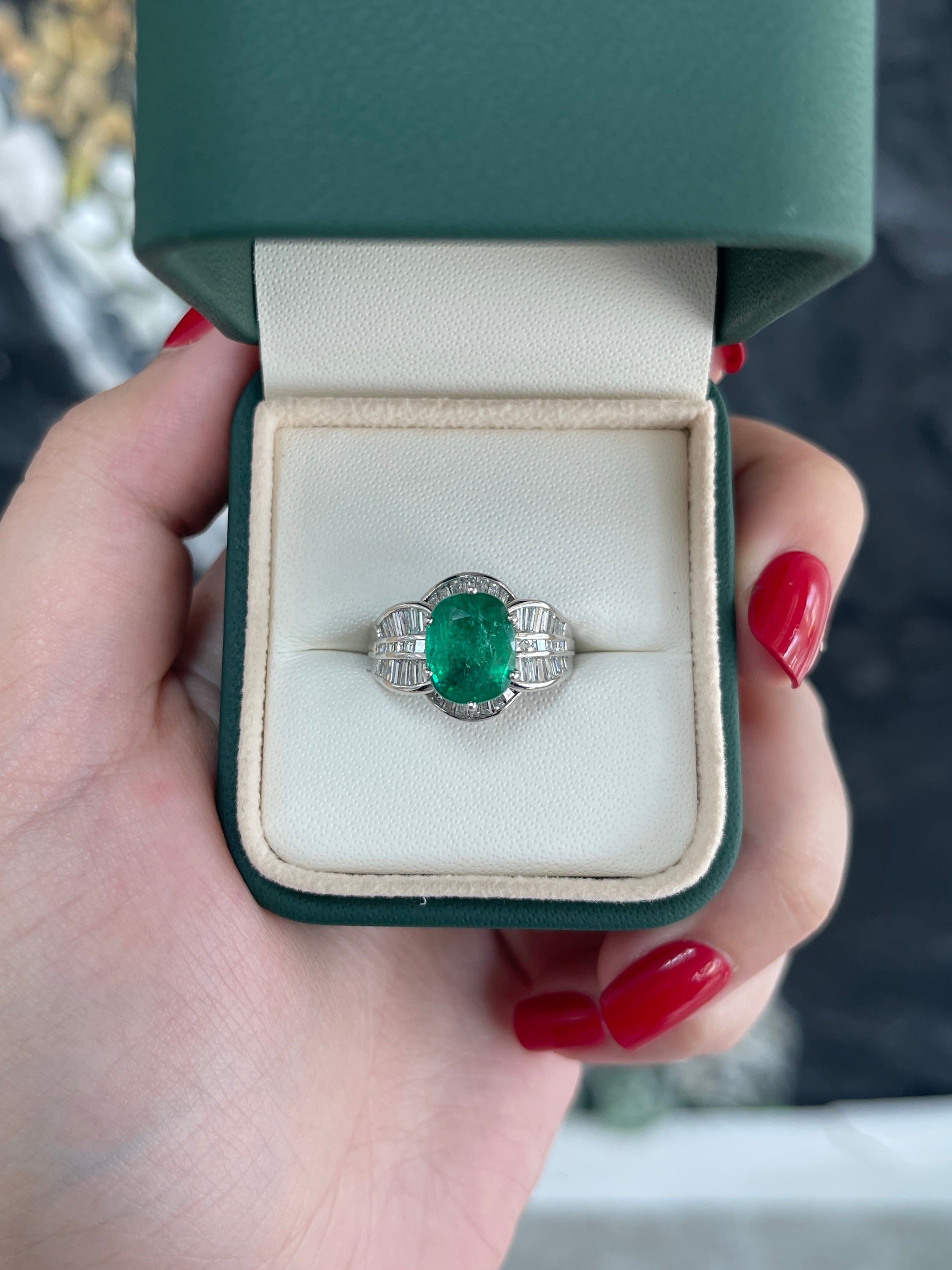 Antique 3.77-carat Colombian emerald and diamond ring in 18K white gold, oval cut with intricate vintage design.