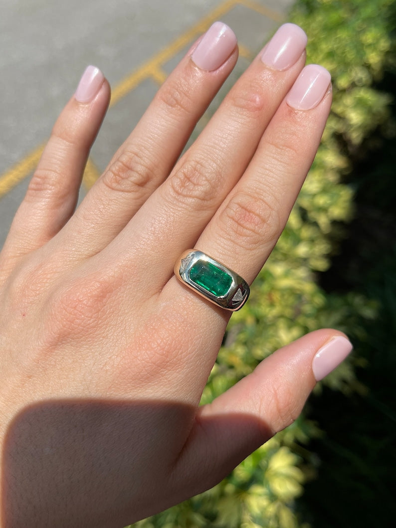 14K gold east-to-west emerald and diamond triangle ring featuring rich green emeralds and sparkling diamonds in a chunky design