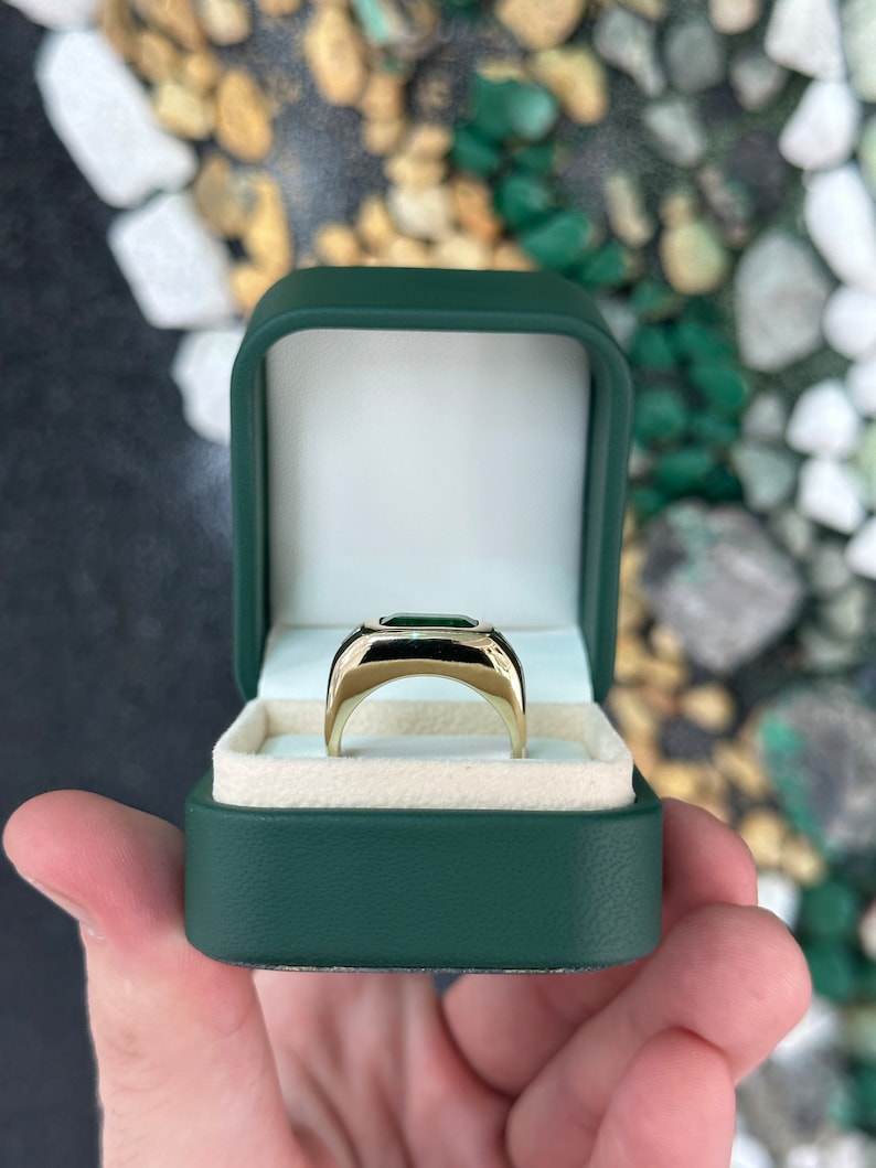 14K gold east-to-west emerald and diamond three-stone ring with chunky design and rich green emeralds, from Colombian Emerald.