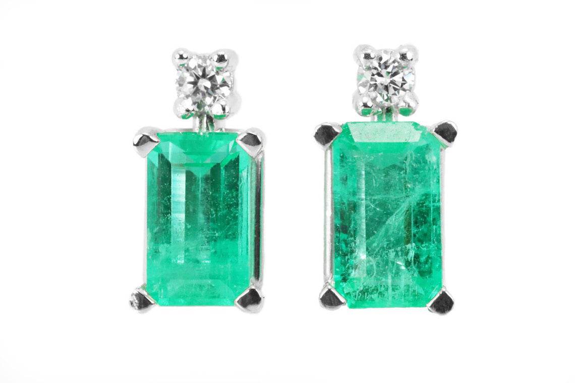 Pair of 1.56tcw earth mined emerald and diamond stud earrings set in 14K white gold