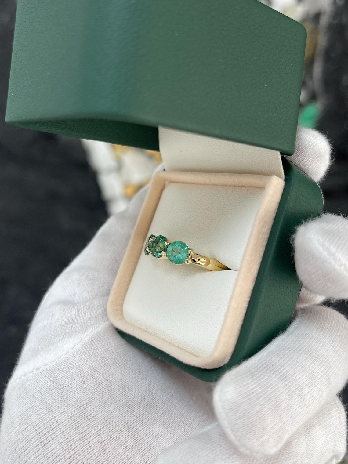 Ladies 2.20 carat round emerald three-stone band ring in 14K gold with prong setting, featuring rich green Colombian emeralds.